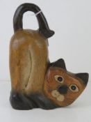 A carved and painted wooden figurine of a cat, 23cm high.