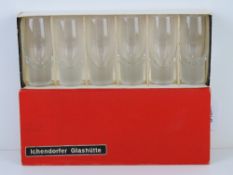 A boxed set of six tall shot glasses with solid spun bases within original box bearing label