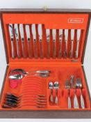 A part set of cutlery by Oneida in leather topped canteen.