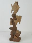 A wooden carving of fish in a 'coral reef', 37cm high.
