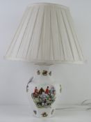 A hunting themed ceramic table lamp with white silk shade, all standing 55cm high.