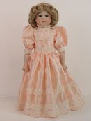 A handmade 20th century bisque headed doll made using an antique doll mould,