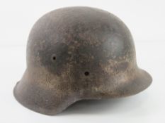 A WWII German M42 single decal (indistinct) semi relic Afrika Korp Army helmet.