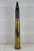 An inert 57mm MLE shell, case dated 1947