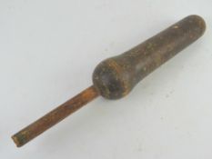 An antique wooden baton.
