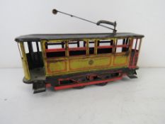 A tin plate clockwork tram measuring approx 17cm in length.