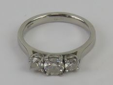 A platinum trilogy diamond ring having approx 0.
