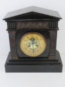 Tiffany & Co; a late 19th century Architectural polished slate mantel clock having gilded chapter