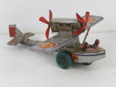 A Cable Balon tin plate clockwork Litho Plane measuring approx 18cm in length.