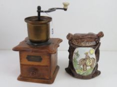 A phoenix Gesmeed Binnenwerk brass coffee grinder together with a tea canister. Two items.
