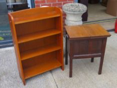 A c1930s oak slid-top work/sewing table opening to reveal compartment within, 52 x 41 x 63cm.