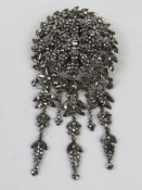 An impressive 19th century cut steel brooch having central floral panel with wreath surrounding and