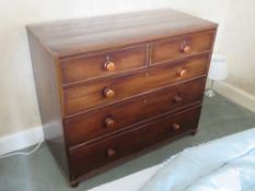 A late Georgian mahogany chest of two short over three long drawers all with matching turned