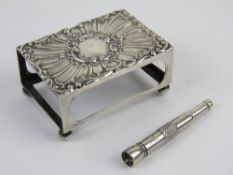 A large size HM silver matchbox cover raised over ball feet,