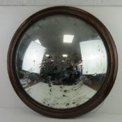 A large Victorian mahogany framed bullseye wall mirror measuring 80cm dia, old damage to silvered
