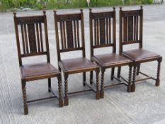 A set of four oak 1930s high back Caroleon Revival dining chairs drop-in leatherette seats.