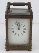 A French made five glass brass cased carriage clock. Enamelled face and Roman numerals, all before