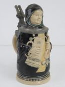 A pewter and ceramic tankard in the form of a a Prior holding a tankard and quantity of parsnips,