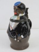 A 19thC unusual figural ceramic beer stein, the pewter collar marked LBCM (Leo Lindenblatt