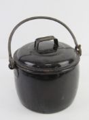 A black enamel Judge Ware fireplace lidded pot with swing handle over.