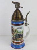 A military themed beer stein having fuze style lid with cannon decoration upon, German