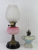 A late Victorian oil lamp have pink opaline glass reservoir oil lamp having frosted glass shade,