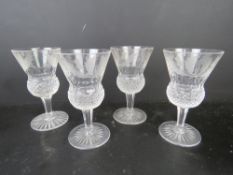 A set of four etched Scottish lead crystal glasses of thistle form having etched thistle design