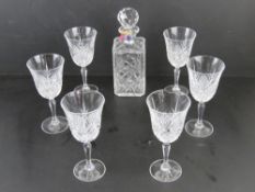 A Thomas Webb square shaped lead crystal decanter having label upon, together with six cut glass
