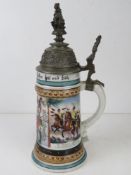 A military themed ceramic beer stein having Hussar on horseback with crest to handle,