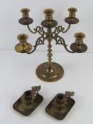 A brass fire sconce candelabra together with a pair of German brass chamber sticks.