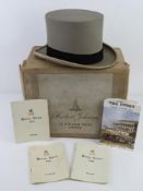 A grey felted top hat by Moss Bros of Covent Garden size 6 7/8 within Herbert Johnson 38 New Bond