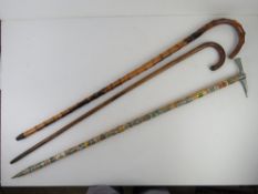 An early 20thC walking cane having inlaid white metal art nouveau leaf design upon together with a