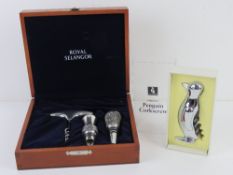 A cased corkscrew in the form of a penguin together with a boxed Royal Selangor corkscrew and wine