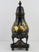 A 19thC pewter Dutch tole and Japanned tea urn of pear shape with an urn finial,
