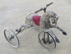 A delightful early 20thC child's tricycle in the form of a prancing pony. Steerable front wheel with