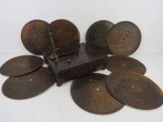 A Victorian tabletop symphonion, being rosewood effect pine box with hand cranked movement upon,