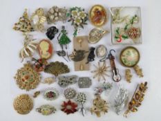 A quantity of 20thC costume jewellery brooches inc pewter Labrador pin, embroidered brooch, German