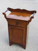 A c1930s pot cupboard / wash stand having single drawer with brass drop handle and door under,