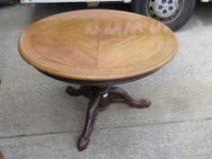 A fine quarter panelled oak low round occasional table raised over bulbous reeded stem upon three