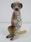 An unusual Raku South African ceramic figurine of a meerkat in crackle glaze standing 13.5cm high.