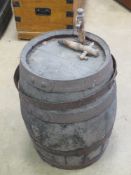 A coupered and banded vintage liquor barrel standing 55cm high completed with vintage wooden tap.