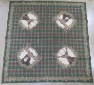 A German hunting themed tablecloth by Franchris having stags and two moose upon with tartan type