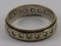 A 9ct gold eternity ring hallmarked Birmingham 1965 set with white stones (possible spinel) size O-