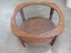 A c1960s light mahogany glass top coffee table measuring 69 x 69 x 37cm.