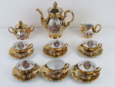 A 1920s Royal Bavaria Handgemalt gilded tea service comprising six cups and saucers, teapot, cream