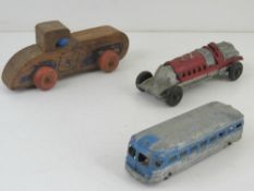 An American made cast metal racing car toy together with Greyhound Line bus and wooden US Scout