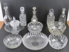 A quantity of assorted cut glass decanters and fruit bowls, etc. Also a ceramic Gin collar label.