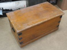 A late 19thC pine lidded trunk with end handles.