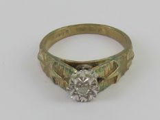 A 9ct white gold ring having central illusion set diamond with star pattern shoulders, hallmarked