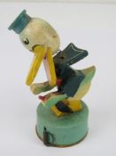 Sewing ephemera; A vintage fabric retractable tape measure in wooden casing in the form of a duck